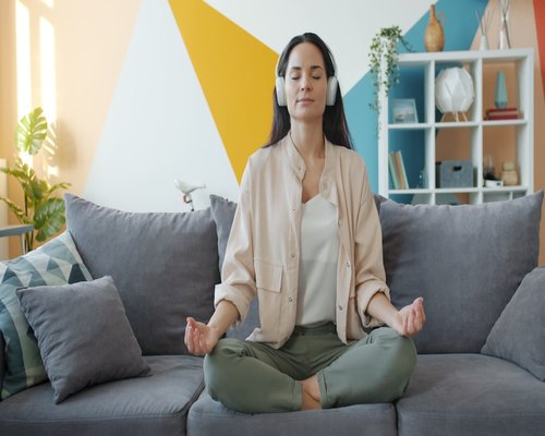 Indian woman practicing meditation at home