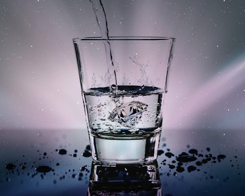 Person drinking water from a glass in the morning